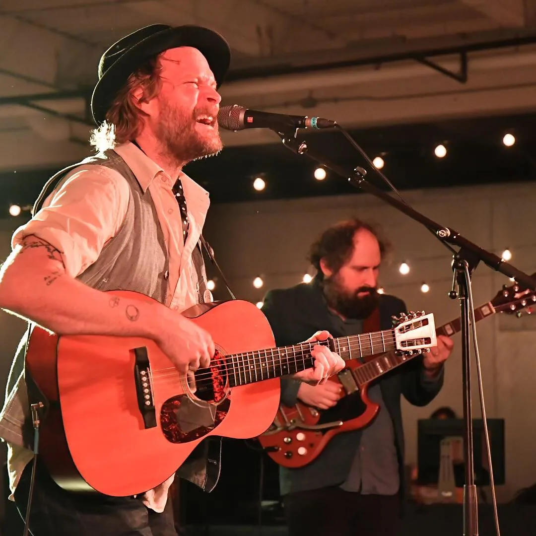 Hiss Golden Messenger performing live in an archival photograph