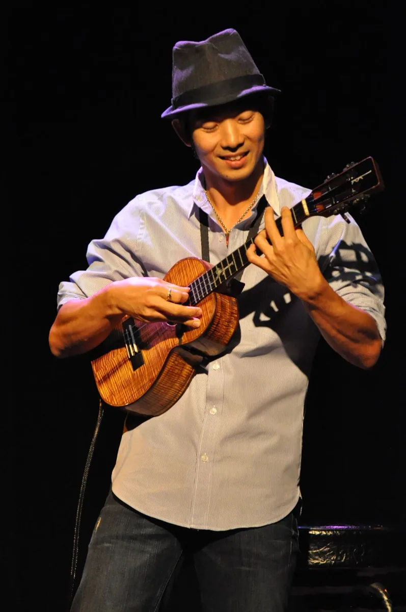 Jake Shimabukuro performing live in an archival photograph